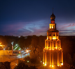 Fototapeta na wymiar St. George's bell tower and evening city from a height. Ukraine, Krivoy Rog
