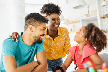 child family woman home happy man father mother lifestyle happiness daughter  together parent love bonding cheerful fun table