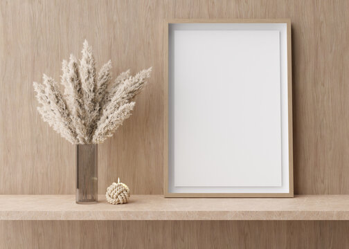 Empty vertical picture frame standing on shelve in modern room. Mock up interior in contemporary style. Free, copy space for picture. Pampas grass in vase, candle. 3D rendering.