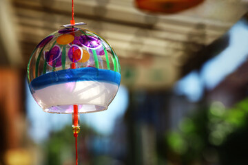 The eaves of a shop where a wind chime called 