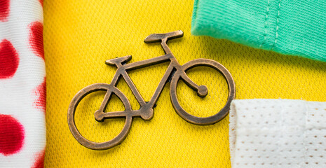 Golden bike pin on some colorful tour de france t-shirts