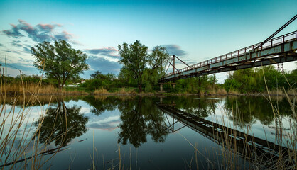 Sunset panorama of railway bridge and industrial city