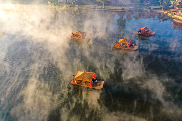 Fototapeta premium Aerial view of Sunrise with fog over Ban Rak thai, chinese village near a lake in Mae Hong Son, Thailand