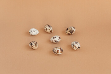 Quail eggs on a beige background, top view. Minimalist egg design, modern design template.