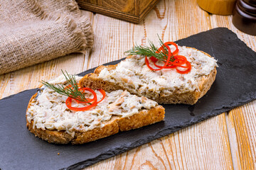 bruschetta with sprat on a wooden table