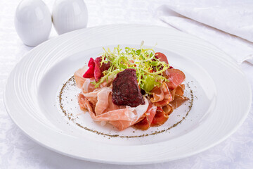 slicing of different meat on a white plate macro close up
