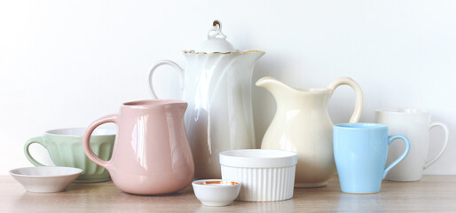jugs, mugs and bowls in a row
