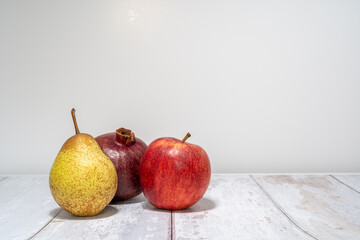 pear, apple and pomegranate isolated on white background. healthy eating concept