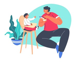 Dad feeding small boy sitting in chair, parenthood