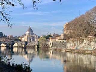 Fototapeta na wymiar Beautiful views of the Vatican City on the banks of the Tiber River on a sunny morning