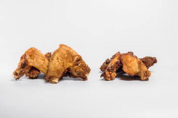 fried chicken wings in oil and breadcrumbs lie on a white background for three pieces