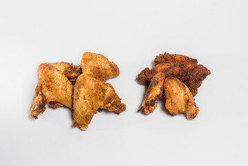 fried chicken wings in oil and breadcrumbs lie on a white background for three pieces