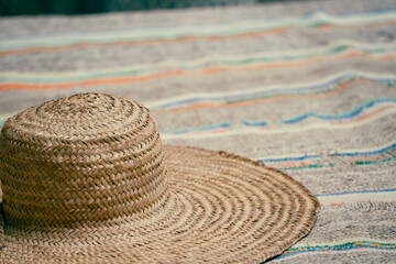 Fototapeta na wymiar Straw hat on a blanket
