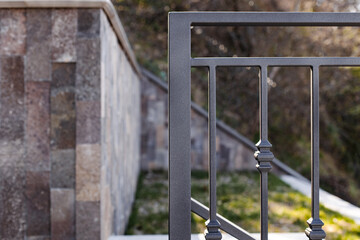 Modern metal railings and handrails in the loft style. The metal is treated with a primer and...