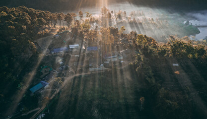 Aerial view of Sunrise with fog over Ban Rak thai, chinese village near a lake in Mae Hong Son, Thailand