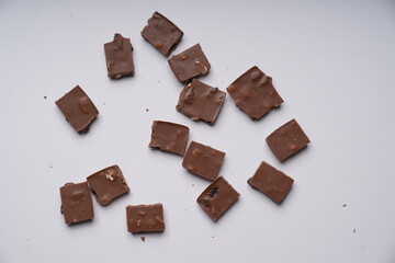 milk chocolate with hazelnuts and raisins is isolated on a white background. cooking concept