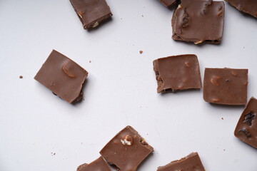 milk chocolate with hazelnuts and raisins is isolated on a white background. cooking concept
