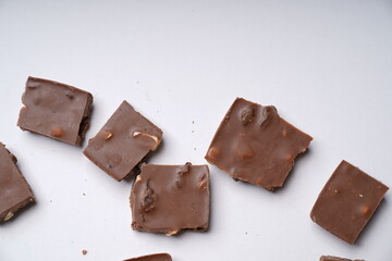 milk chocolate with hazelnuts and raisins is isolated on a white background. cooking concept