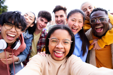 Big group of cheerful young friends taking selfie portrait. Happy students people looking at the camera smiling. Concept of community, colleague, youth lifestyle and friendship