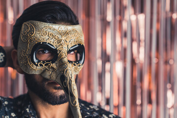 carnival is starting - bearded man in the mysterious mask closeup indoors mystery concept. High...