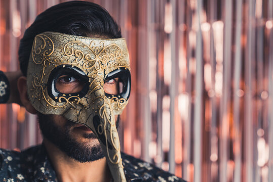 carnival is starting - bearded man in the mysterious mask closeup indoors mystery concept. High quality photo