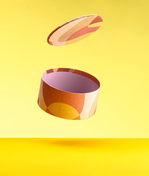 Round handmade box with lid on yellow background. The concept of minimalism. Poster for advertising. Place for text
