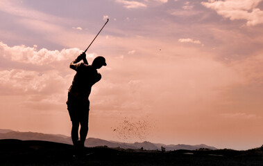 silhouette of a golfer in mid swing - Powered by Adobe
