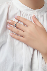 Manicured womans hand with trendy minimal jewelry