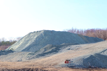 piles of asphalt crumbs and rubble and a construction cart