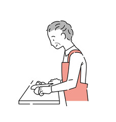 まな板の食材を包丁で切る年輩男性