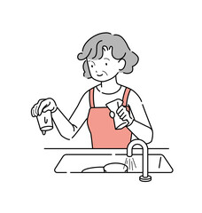 シンクの中の食器を洗う年輩女性