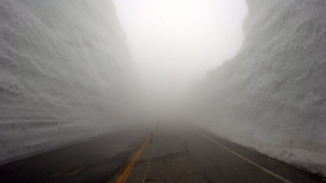Toyama,Japan - April 23, 2022: Snow wall at Murodo under dense fog
