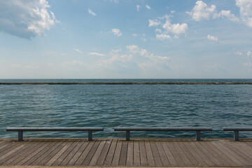 wooden pier on the lake (with blue sky and clouds)