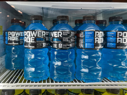 Houston, TX, USA - March 10, 2022: Powerade Mountain Berry Blast Sports Drink 28 FL OZ bottles on the shelf in a freezer at a grocery store.