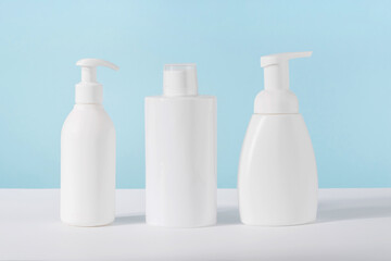 Cleaning agent, detergent and liquid soap dispenser bottle on blue background. Product presentation...