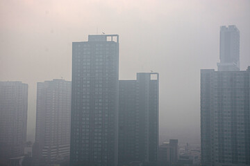 Residential buildings are covered with pollution dust.