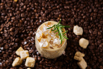 Iced latte coffee. Cup of Iced latte coffee, milk tea on dark coffee seeds background. Could Coffee...