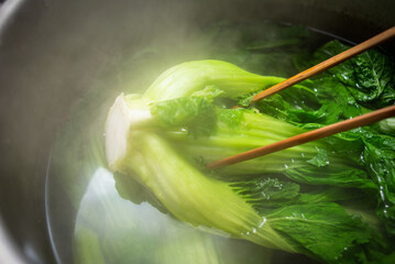 Boiled mustard greens to make sauerkraut