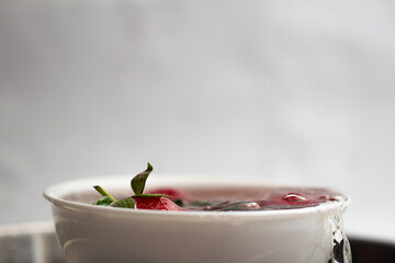 strawberry and water splash on white background