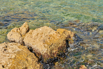 huge stones lie in the water in the sea