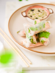 Raw spring rolls with salmon and vegetables  with soy sauce closeup food photography 