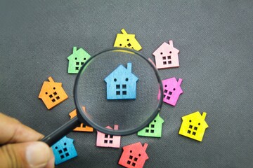 magnifying glass looking for a home. the concept of Property inspection or home search