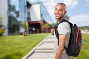Naklejka premium Happy young student at the university background