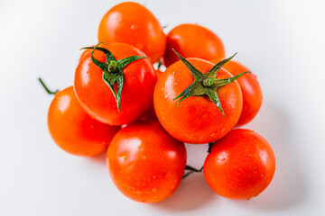 Bunch of ripe tomatoes with one source of natural light. Ripe tomatoes on vine