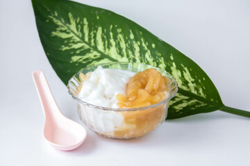 Sweet Rice Noodles with Coconut Cream in a glass cup on a white table.