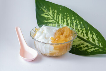 Sweet Rice Noodles with Coconut Cream in a glass cup on a white table.