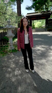 Young Woman in Japanese Garden Viewing Cherry Blossoms