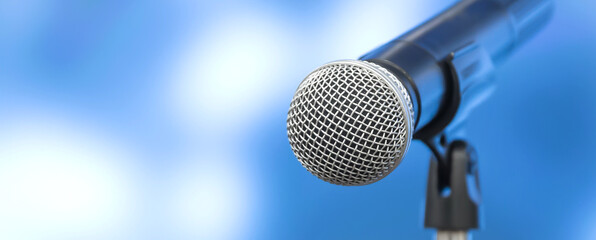 Microphone with stage light background for performance concept of speech comment and public speaking