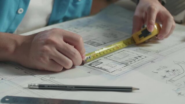 Close Up Of Hand'S Man Engineer Measuring Blueprint At The Office
