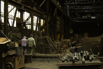 Industrial foundruy with two workers